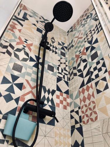 a shower in a bathroom with mosaic tiles at Blue Flamingo Apartment in Torremolinos