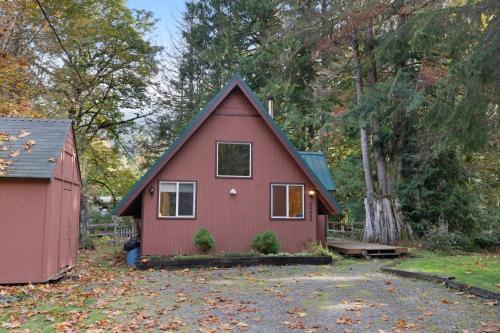 a red house with a gambrel roof at Cedarwood Grove in Baring