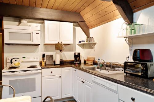 a kitchen with white cabinets and a sink at Cedarwood Grove in Baring