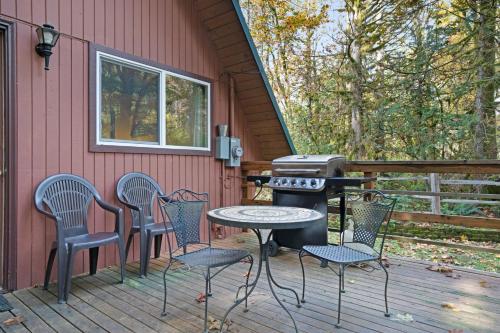 a patio with chairs and a grill on a deck at Cedarwood Grove in Baring