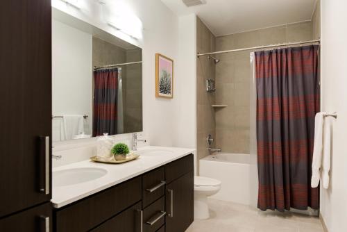 a bathroom with a sink and a toilet and a shower at Mint House Houston - Medical Center in Houston