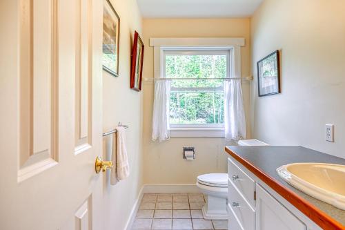 a bathroom with a sink and a toilet and a window at Compass Rose in Seal Cove