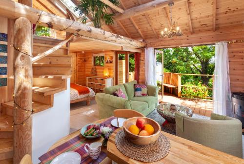 a log cabin living room with a wooden ceiling at Porthole Log Cabin in Minehead
