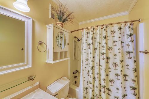 a bathroom with a toilet and a shower curtain at Hilton Head Resort in Hilton Head Island