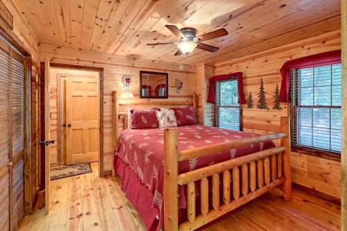 a bedroom with a bed in a log cabin at Cozy Bear in Sautee Nacoochee