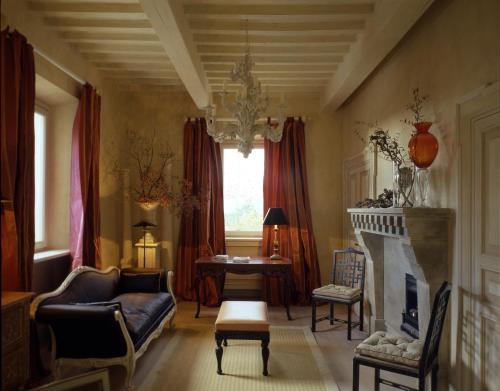 a living room with a couch and a fireplace at L'Andana Tenuta La Badiola in Castiglione della Pescaia