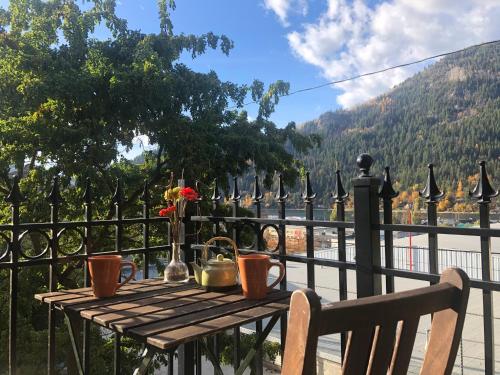 a wooden table on a fence with tea pots on it at Mistiso's Place Vacation Rentals in Nelson