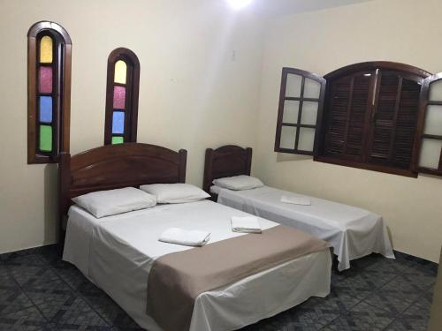 Ένα ή περισσότερα κρεβάτια σε δωμάτιο στο Pousada Beach