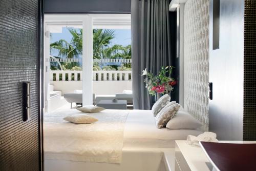 a bedroom with a large bed and a balcony at Damianii Luxury Boutique Hotel & Spa in Omiš