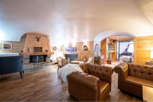 a living room filled with furniture and a fireplace at Hotel La Montagne in La Clusaz
