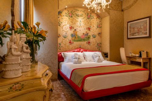 a bedroom with a bed and a vase of flowers at Hotel Santo Stefano in Venice