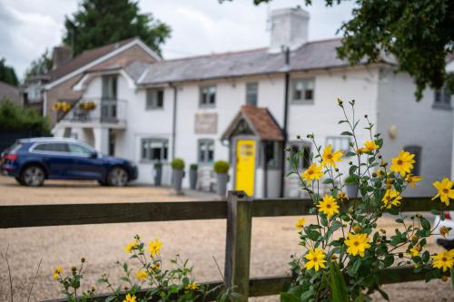 a house with a blue car parked in front of it at Cottage Lodge Hotel in Brockenhurst