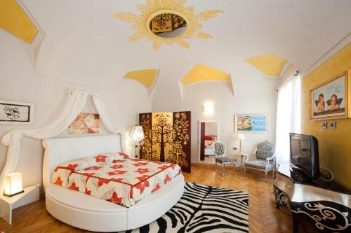 a bedroom with a bed and a tv in it at Lori's Inn in Mondovì