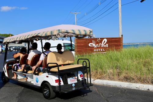 a group of people riding on a golf cart at Harbor Hotel Provincetown in Provincetown