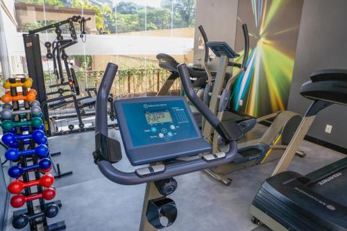 a gym with cardio equipment and a simulator at EXCELENTE Flat junto aos Shoppings JK e Vila Olimpia in Sao Paulo