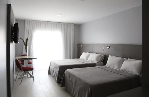 Una cama o camas en una habitación de Termas de Miraflores Hotel Termal