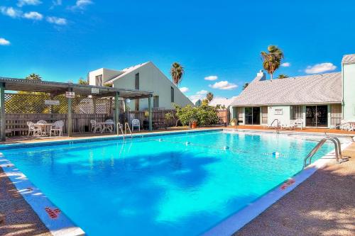 a swimming pool with blue water in front of a house at Puente Vista in Corpus Christi