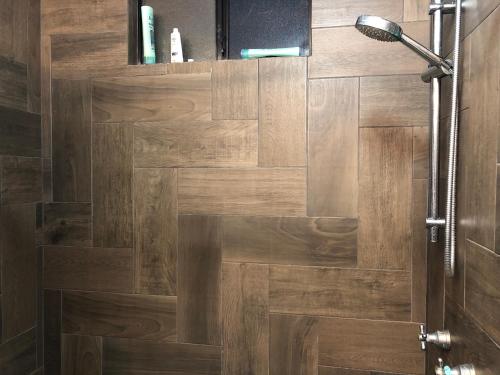 a bathroom with a shower with a wooden door at Modern Hacienda in Ensenada