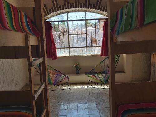 a room with two bunk beds and a window at El Sunset Hostel in Puerto Vallarta