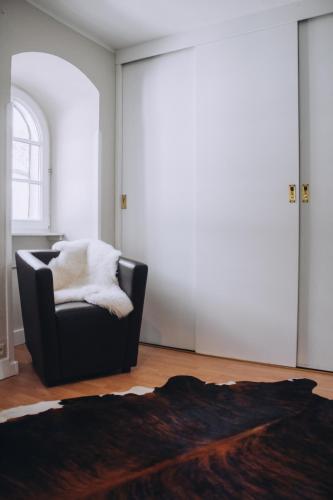 a living room with a chair and a window at Landfein-Villa Marathon in Winterberg