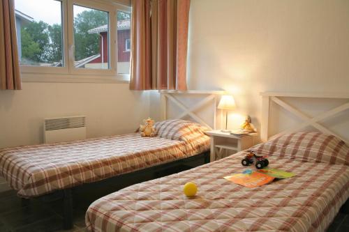 Llit o llits en una habitació de Résidence Néméa Les Rives de Saint Brice