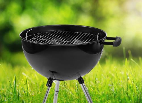 a black grill on a stand in the grass at Extended Stay America Suites - Fort Lauderdale - Cypress Creek - NW 6th Way in Fort Lauderdale
