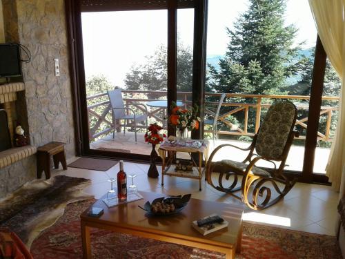 a living room with a couch and a table at Elatos cozy Studio in Ano Trikala