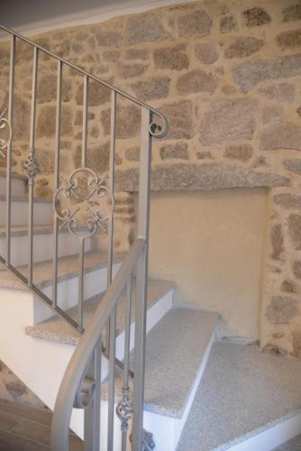 a staircase in a stone building with a stone wall at La Dimora di San Simplicio in Olbia