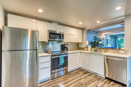 a kitchen with white cabinets and a stainless steel refrigerator at Hip Nautic in Florence