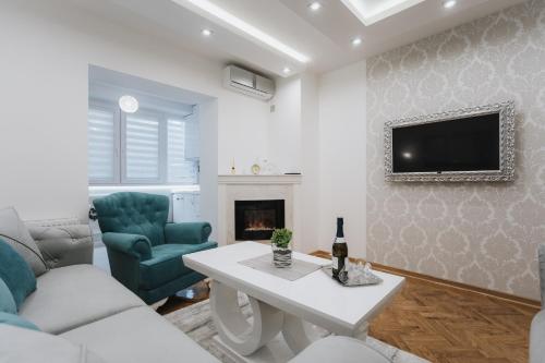 Una sala de estar con un sofá y un televisor. en Three Sons Apartment, en Novi Sad