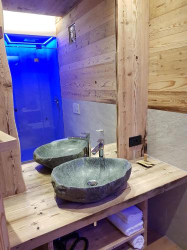 two sinks on a wooden counter in a bathroom at AGRITURISMO La Giasena in Ponte nellʼAlpi