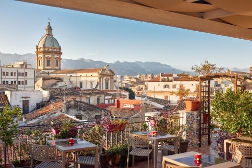 a view of a city from a restaurant with tables at La Terrazza sul Centro in Palermo