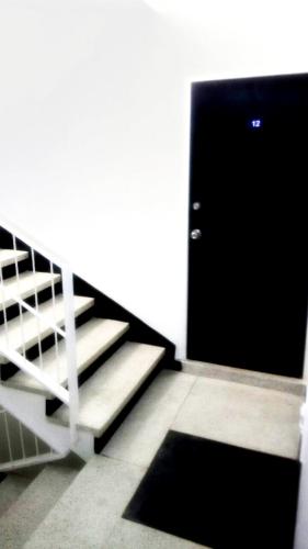 a room with a door and stairs with a rug at Hotel Casa Guillermo in Bogotá