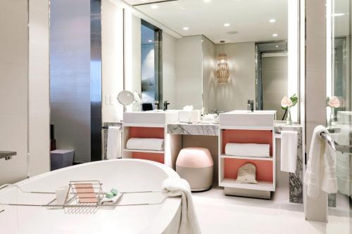 a white bathroom with a tub and a sink at Sofitel Mexico City Reforma in Mexico City
