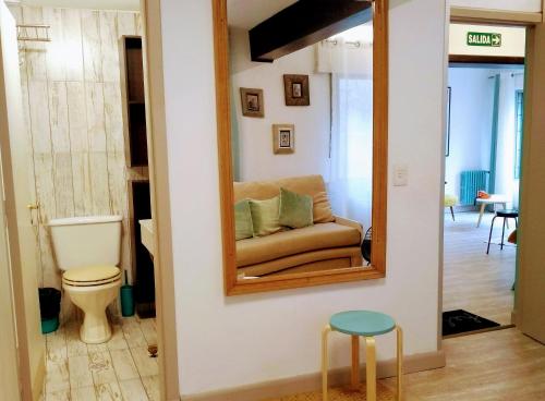 a living room with a mirror and a couch at Vintage Bariloche Hostel Boutique in San Carlos de Bariloche