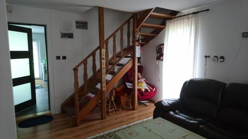 a child sitting in a chair in a room with stairs at Beba in Heřmanovice