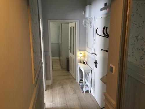 a hallway with a white door and a white sink at My Home, with free secure parking in Stara Zagora