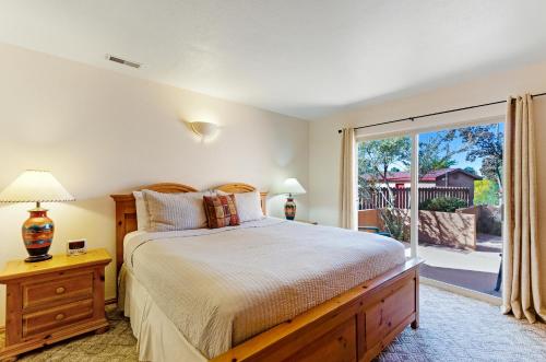 a bedroom with a bed and a large window at Solano Vallejo 3283 in Moab