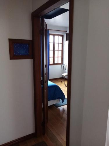 a door leading to a bedroom with a bed in it at Hotel Casa Ecuatreasures Centro Historico in Quito