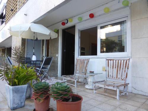 two chairs and an umbrella on a patio at A View to the River Tejo by SixtyFive Boutique Home in Lisbon
