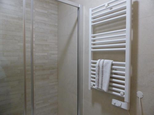 a bathroom with a shower with a window and a towel at A View to the River Tejo by SixtyFive Boutique Home in Lisbon