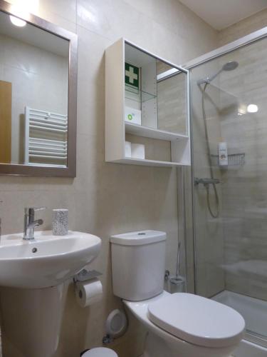 a bathroom with a toilet and a sink and a shower at A View to the River Tejo by SixtyFive Boutique Home in Lisbon