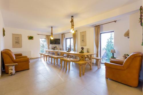 a large living room with a table and chairs at Agropensiunea Mara in Mărişel