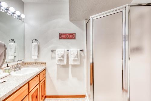 a bathroom with a shower and a sink at Beaches Inn | Sandpiper Pier Cottage in Cannon Beach
