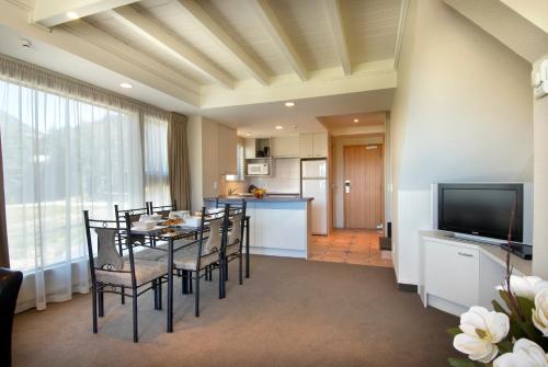a kitchen and dining room with a table and chairs at Hurley's of Queenstown in Queenstown