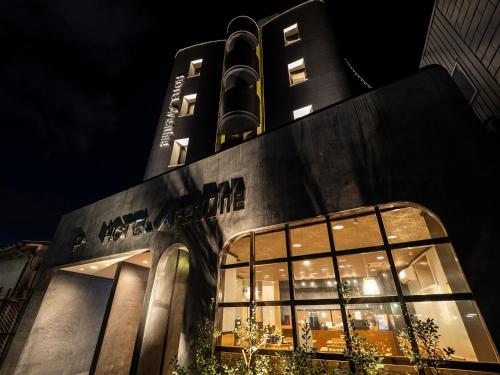 a tall black building with a lot of windows at Hotel AreaOne Izumo in Izumo
