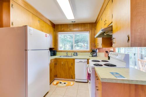 a kitchen with white appliances and wooden cabinets at 8th Hole Getaway Condo MCA #1209 in Manzanita