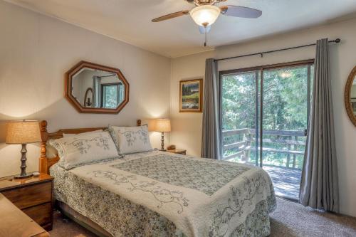 a bedroom with a bed and a large window at Water's Edge Retreat in Shaver Lake