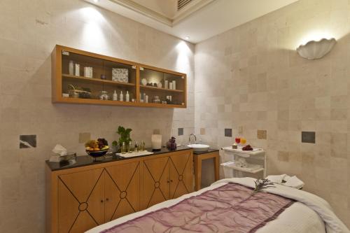 a bathroom with a bed and a counter with a sink at Hotel Marquis Reforma in Mexico City