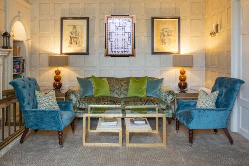 a living room with a couch and two chairs at Lords Of The Manor in Upper Slaughter